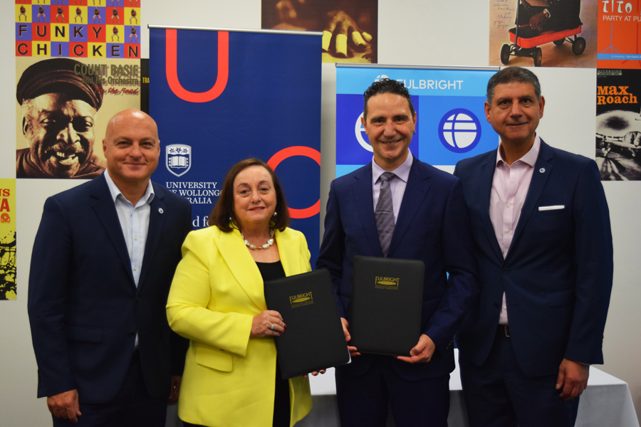 Fulbright and UOW representatives stand with the new Fulbright Scholarship contract