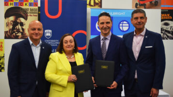 Fulbright and UOW representatives stand with the new Fulbright Scholarship contract